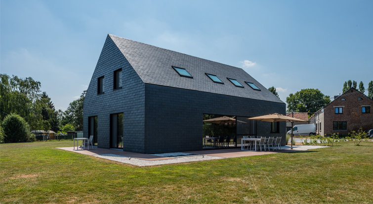 impressive house with slate ventilated façades and pitched roof